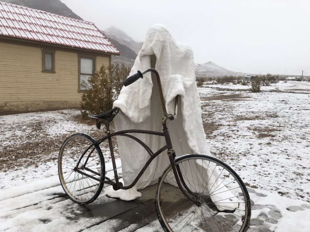 Sculpture covered in snow during winter at Rhyolite ghost town - nearby Death Valley