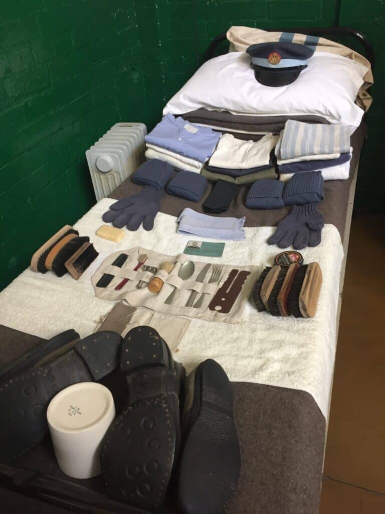 Bed display with clothing and personal items at Apprentice's Barrack Room at Trenchard Museum display at RAF Halton