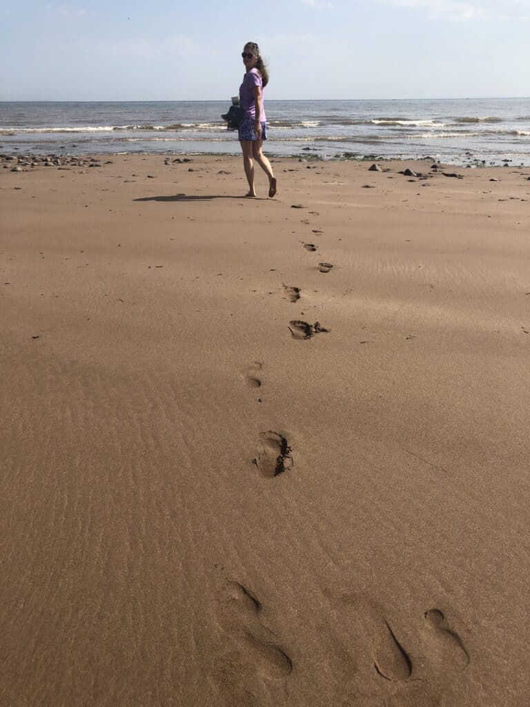 Walking on Dunster Beach - leaving footprints in the sand