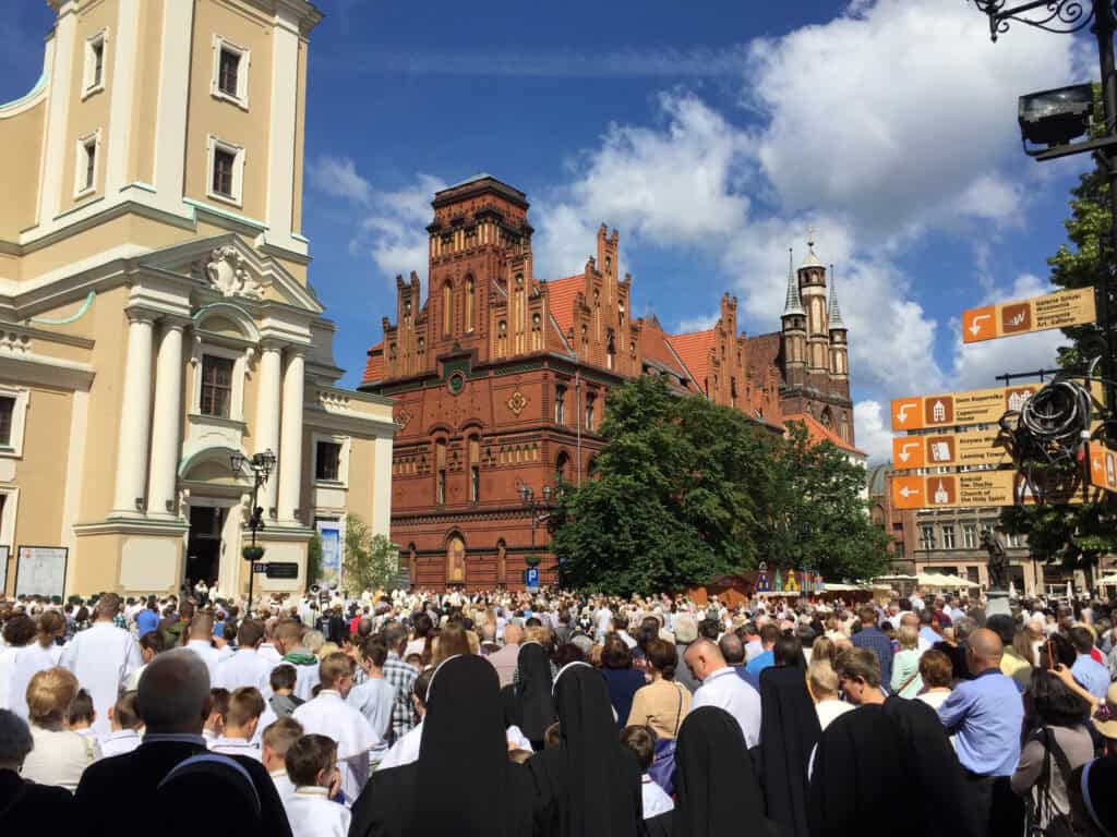 Crowd of people celebrating the feast day of Corpus Christi in Torun, Poland