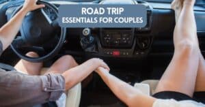 Cover image for article about road trip essentials for couples - showing a couple in a car holding hands