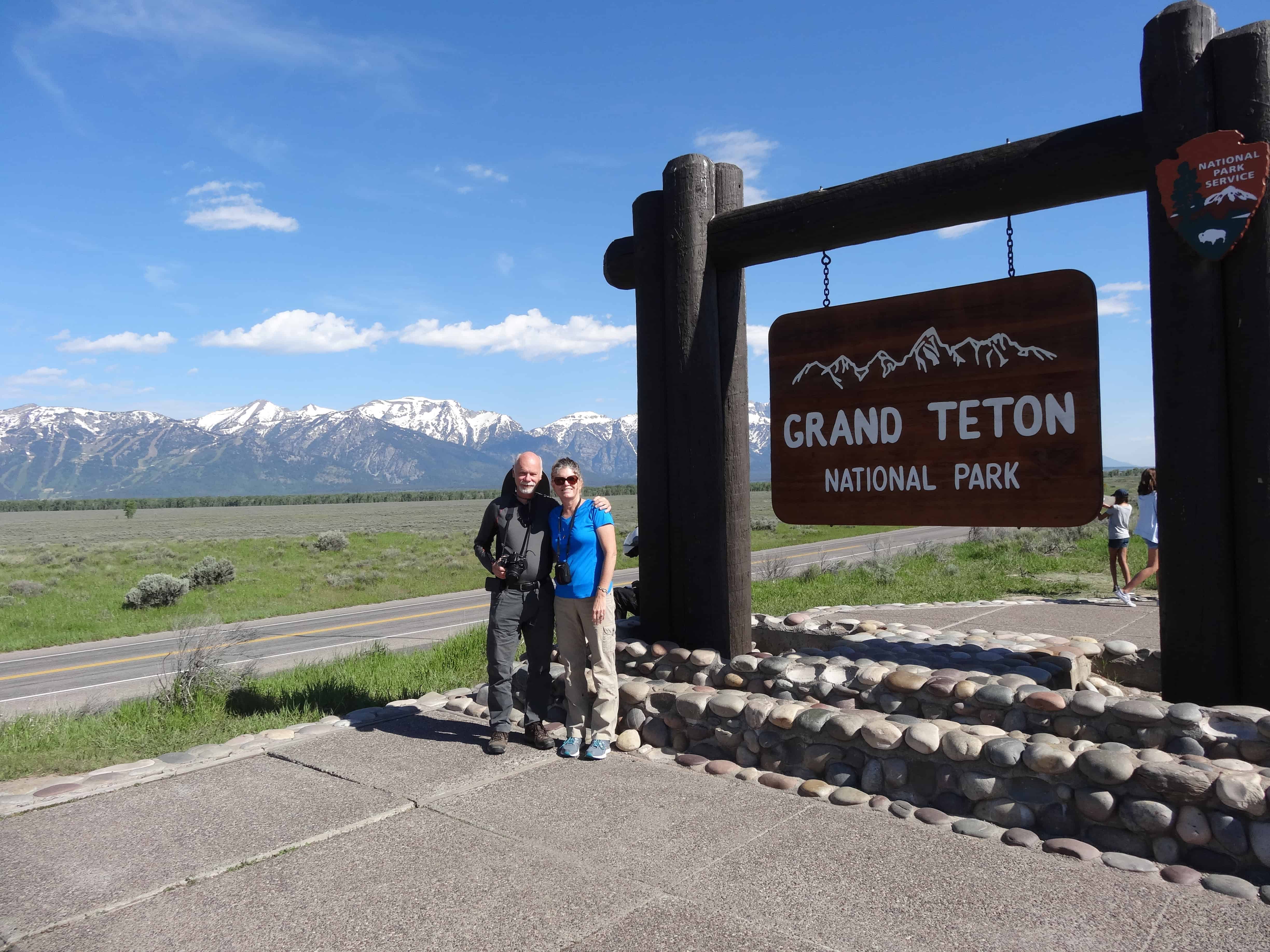 The Places Where We Go in front of Grand Teton National Park sign