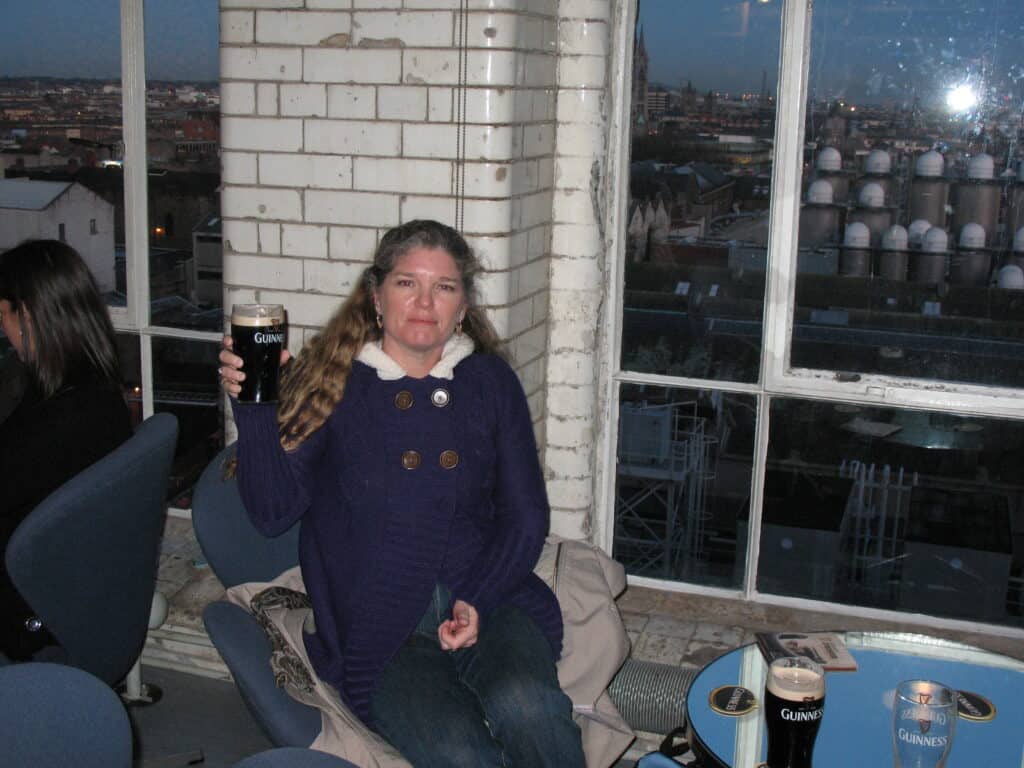 Julie from The Places Where We Go drinking a pint of Guinness