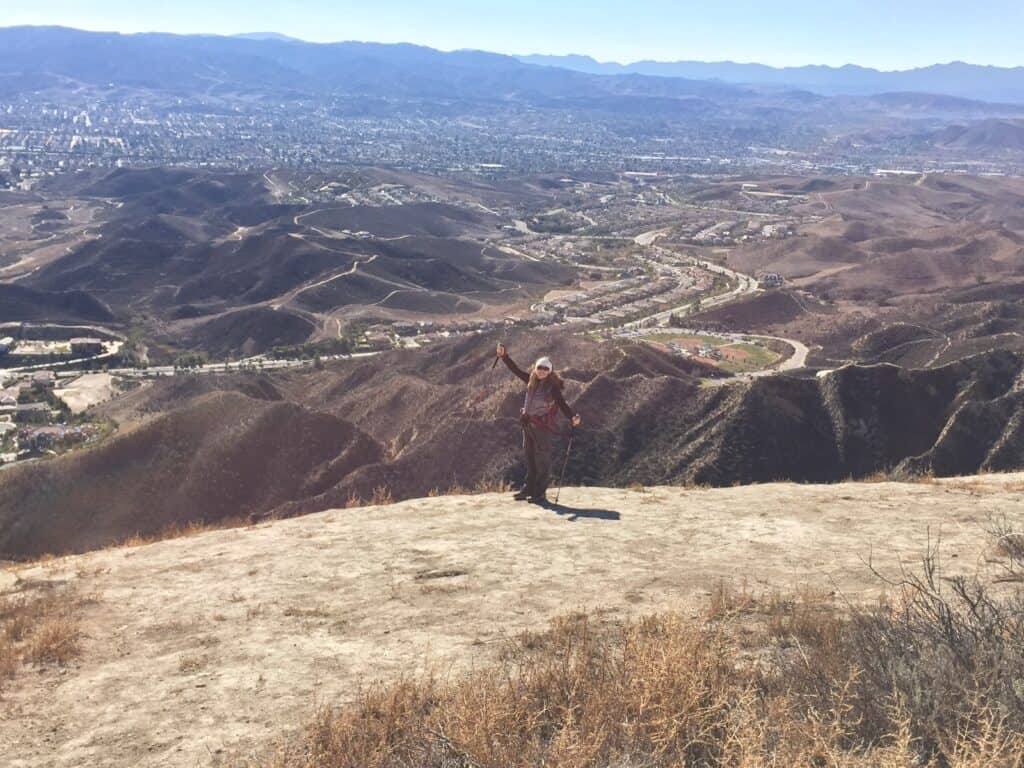 Julie from The Places Where We Go on top of Whiteface Mountain in Simi Valley with a view of the valley