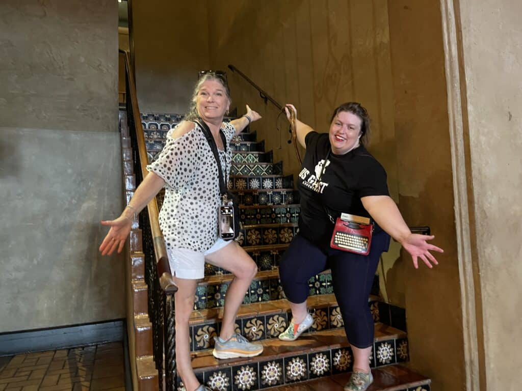 Julie with LA Ghosts Tour Tour Guide on staircase inside Roosevelt Hotel in Hollywood