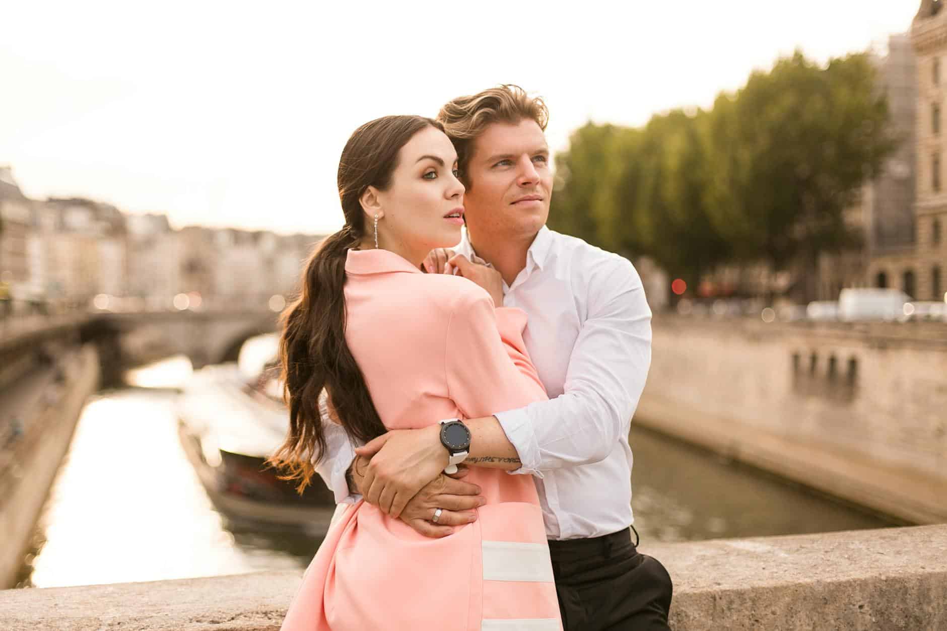 couple embracing by river in city