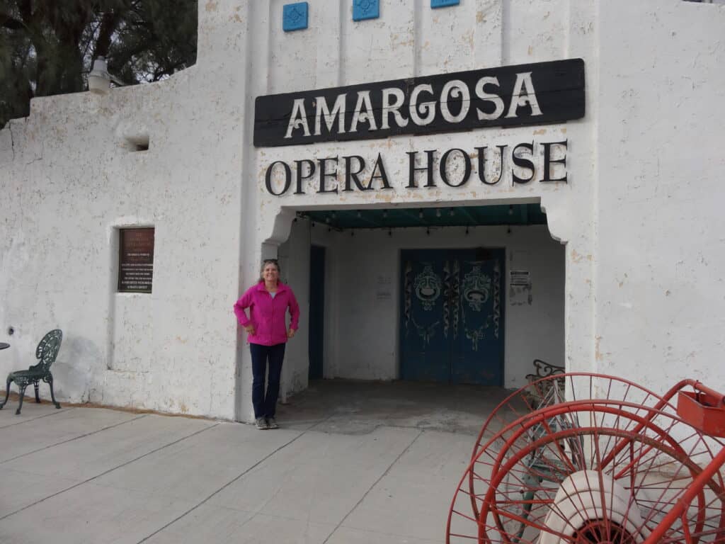 Julie from The Places Where We Go standing in front of the Amargosa Opera House