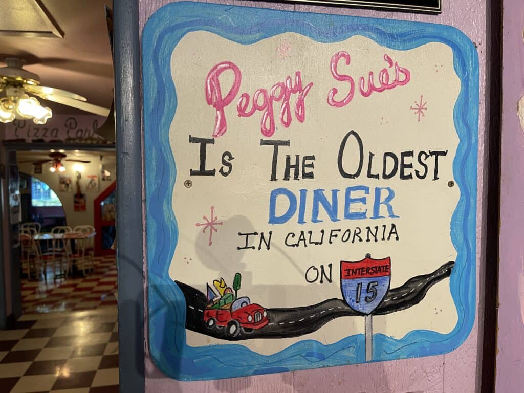 Sign that says Peggy Sue's Diner in Yermo, CA is the oldest diner on I-15