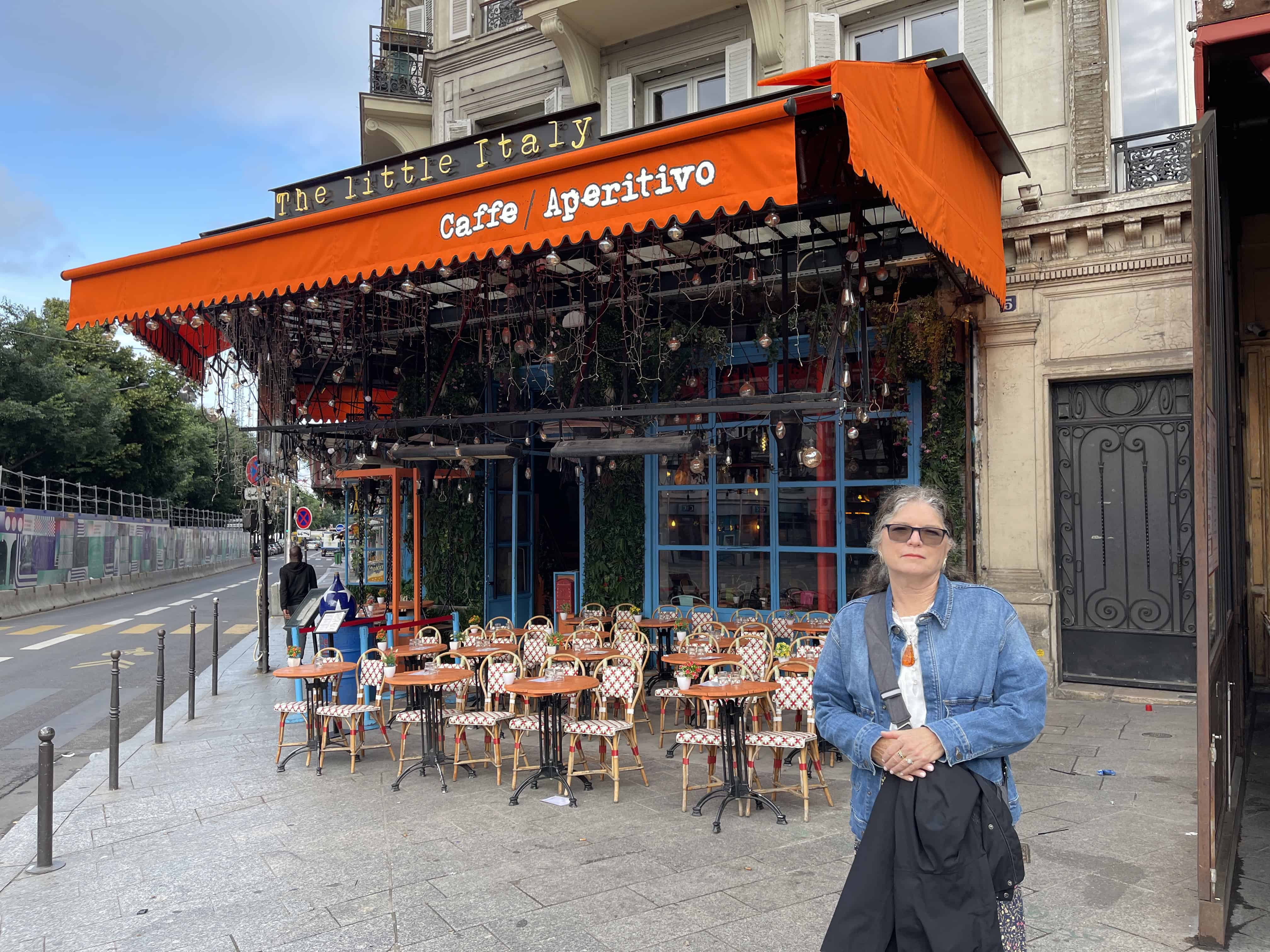 Julie from The Places Where We Go outside The Little Italy Restaurant in Paris