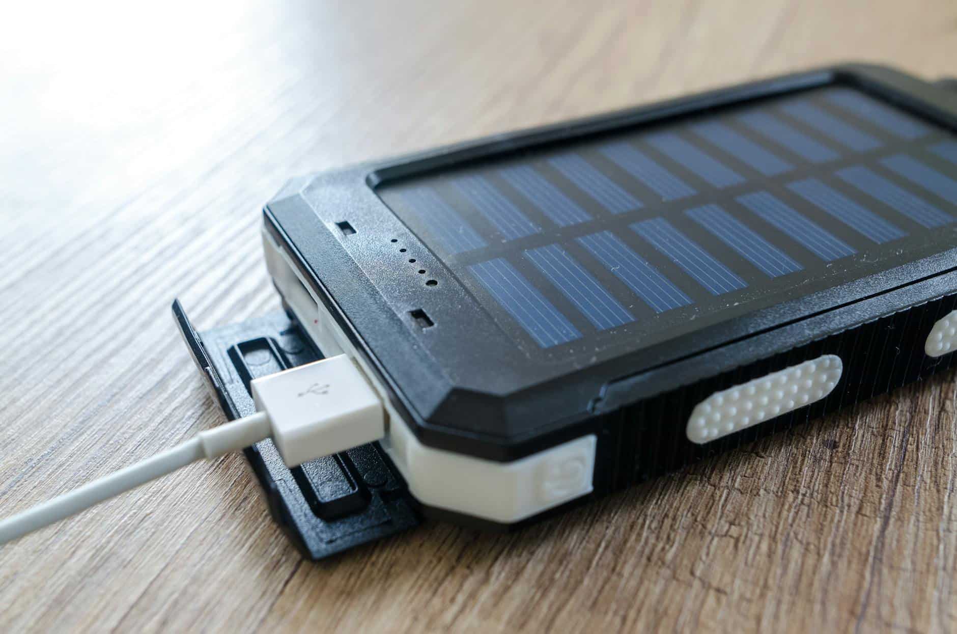 black solar power bank on brown surface