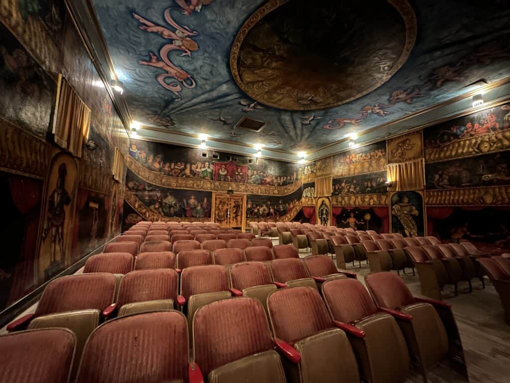Interior of Amargosa Opera House - theater chairs and painted murals on the walls