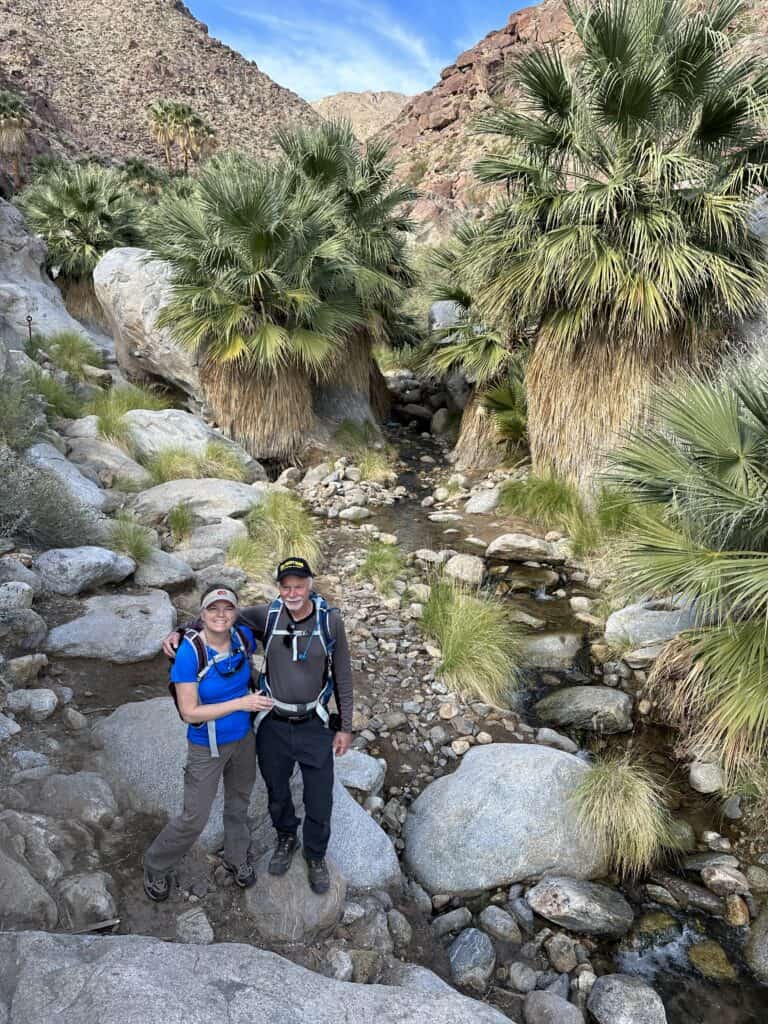 Julie and Art of The Places Where We Go standing at the palm oasis in Anza Borrego desert state park