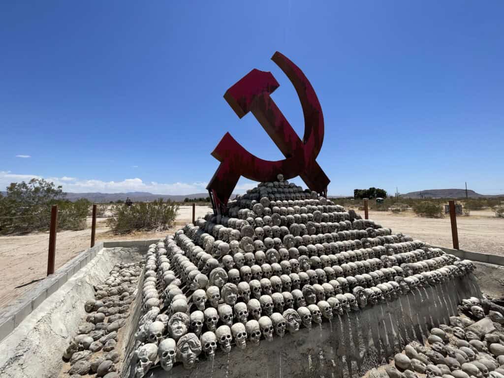 Victims of Communism Memorial at Liberty Sculpture Park in Yermo with hammer-and-sickle symbol on top of hundreds of skulls