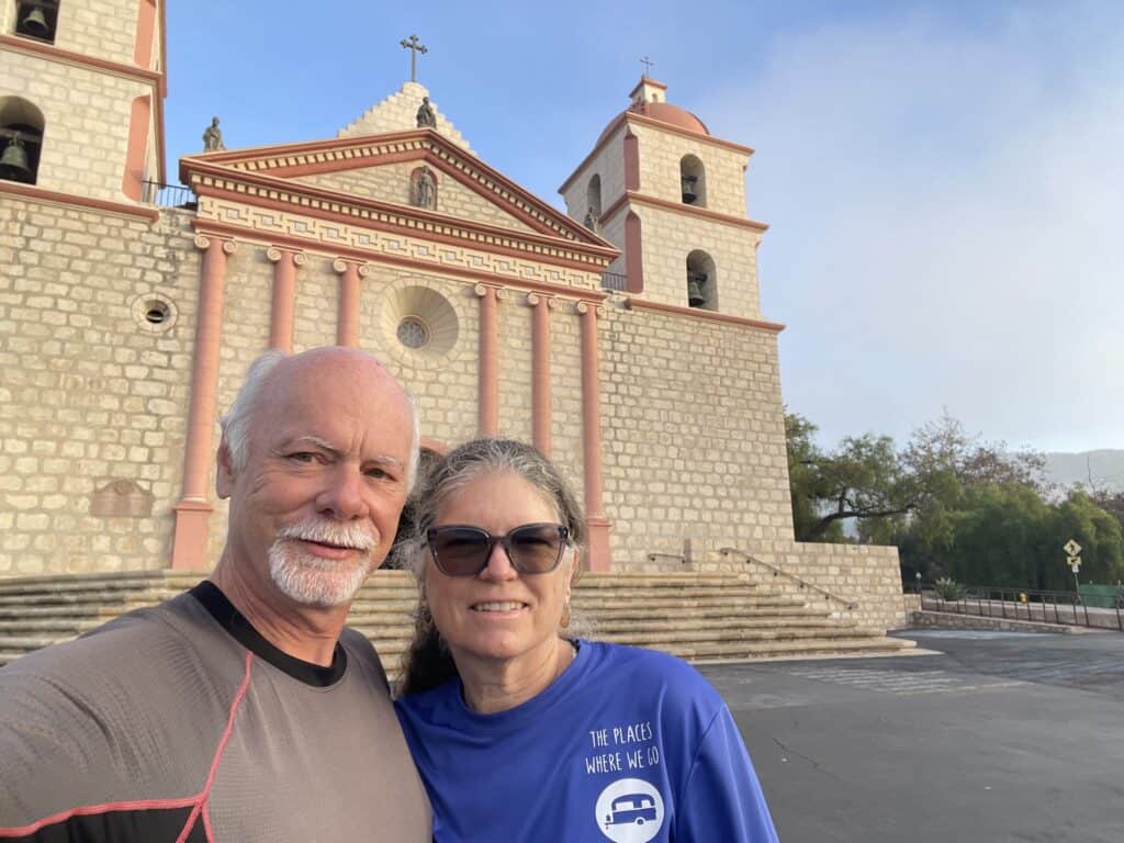 Julie and Art from The Places Where We Go standing in front of the Mission Santa Barbara
