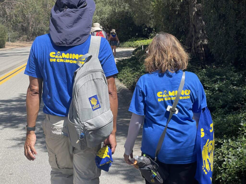 pilgrimage walkers on California Mission Trail - backside of walkers with camino shirts