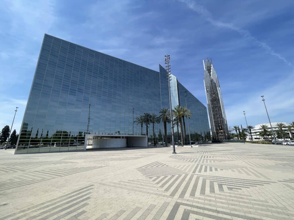 Christ Cathedral in Garden Grove, California, featuring its reflective glass exterior, modern bell tower, and expansive plaza.