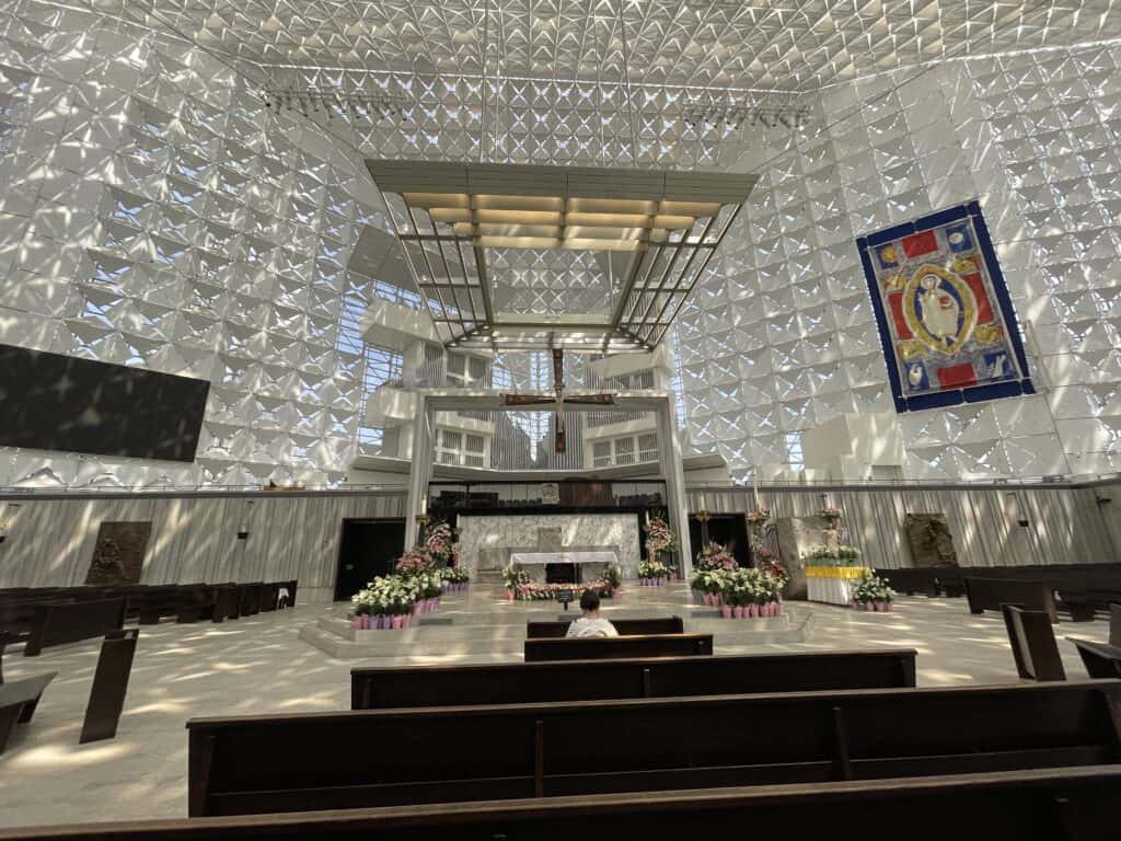 Large suspended crucifix inside Christ Cathedral, surrounded by the pipes of the Hazel Wright Organ and modern glass architecture in the main sanctuary of Christ Cathedral in Orange.